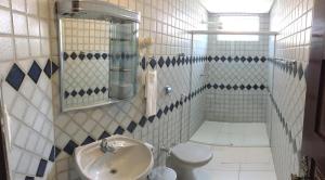 a bathroom with a sink and a toilet at Vila Rica Hotel Caruaru in Caruaru
