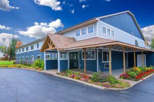 a blue building with flowers in front of it at Northwoods Inn and Suites in Ely