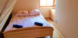 a small bedroom with a bed with two bags on it at Domek Agroturystyczny na Putówce in Słopnice