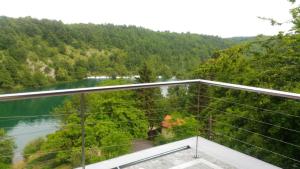 a balcony with a view of a river and trees at Kuća za odmor Zeleni biser in Generalski Stol +21 photos
