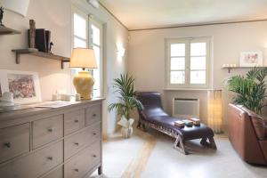 a living room with a chair and a dresser at Relais Villa Isabel in Pietrasanta