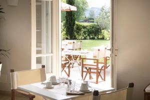 an open door to a patio with tables and chairs at Relais Villa Isabel in Pietrasanta