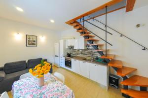 a kitchen and dining room with a table and a staircase at Apartment Loza Pučišća in Pučišća