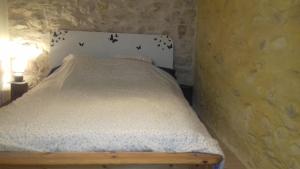 Postelja oz. postelje v sobi nastanitve Le Pigeonnier du Château