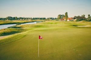 un campo da golf con bandiera rossa sul verde di Zeebriesje a Oostduinkerke