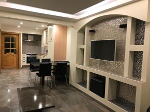 a kitchen and dining room with a flat screen tv at Cintra in Middelkerke +21 photos