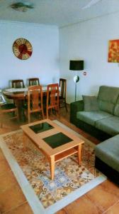 a living room with a couch and a table at Paraiso Huertano in Alquerías