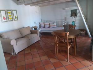 a living room with a couch and a table at Absolute Matala in Matala +36 photos