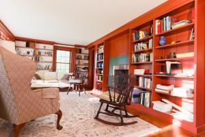 a living room with a book shelf filled with books at Whitford House and Twin View Barn in Addison