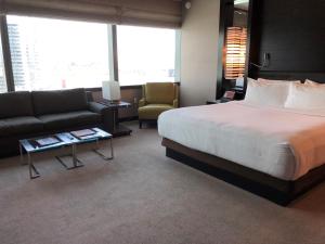 a hotel room with a bed and a couch at Luxury Suites International at Vdara in Las Vegas