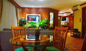 a living room with a table and a couch at Pacific Club Resort in Karon Beach