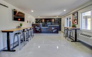 a kitchen with stools and a bar in a house at Americana Modern Hotel in Redding