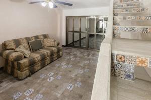 a living room with a couch and a fireplace at Suite Studio Serviced Apartments in Mérida