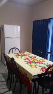 a table with a table cloth with flowers on it at minha casa por dia in Goiânia