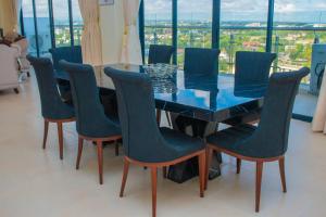 a dining room table and chairs with a view of the city at Nyali Golf View Residence in Mombasa