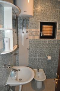 a bathroom with a sink and a toilet at Apartments Olive i Lavender in Mandre