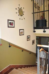 a staircase with a spider clock on the wall at Brauer Panzió in Mecseknádasd