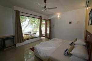 Postel nebo postele na pokoji v ubytování Liberty Guesthouse Maldives