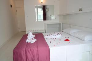 a bedroom with a bed with red hearts on it at Scala Nuova Annex in Cesme