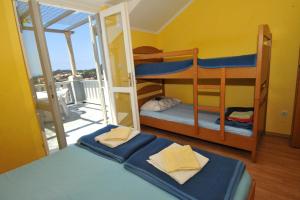 a bedroom with two bunk beds and a balcony at Guest House Banana in Dubrovnik