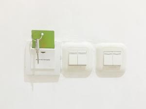 a pair of white electrical switches on a white wall at RedDoorz near Bali Zoo Ubud in Sukawati