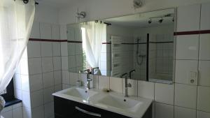 a bathroom with a sink and a mirror at Ar Merglet - Grande longère authentique en Brocéliande in Maxent +36 photos