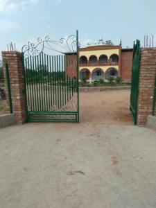 an open gate in front of a building at lalita homestay countryside in Khajurāho