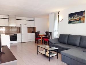 a living room with a couch and a table at Apartamentos Riviera Niza 05 in Salou