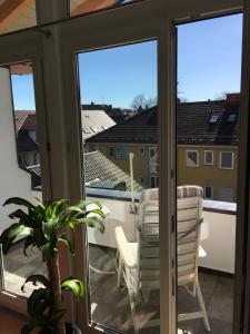 a balcony with sliding glass doors and a table and chairs at Kays Home in Bad Wörishofen