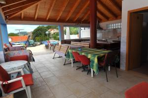 a patio with a table and chairs and a kitchen at Guest House Banana in Dubrovnik