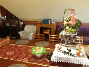 a living room with a table with a no smoking sign at Gabi Guesthouse in Constanţa +20 photos