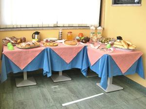 a table with plates of food on it at Caffè Nuovo 2 Holiday Rooms in Trappitello +13 photos