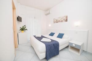 Postel nebo postele na pokoji v ubytování Hotel De Rosa