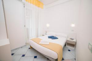 Postel nebo postele na pokoji v ubytování Hotel De Rosa