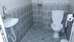 a bathroom with a toilet and a sink at Къща Нанси in Sunny Beach +24 photos