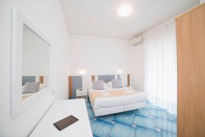Postel nebo postele na pokoji v ubytování Hotel De Rosa