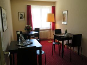 a hotel room with tables and chairs and a window at Landhaus an der Thur in Alt Sankt Johann