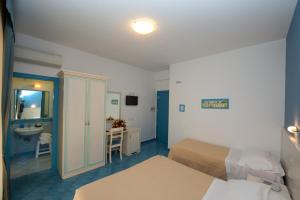 Postel nebo postele na pokoji v ubytování Hotel De Rosa