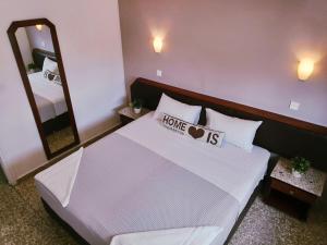 a bedroom with a large bed with a large mirror at Napa City Apartments in Ayia Napa