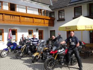a group of people on motorcycles parked in front of a building at Haus Edlinger in Sankt Georgen ob Murau