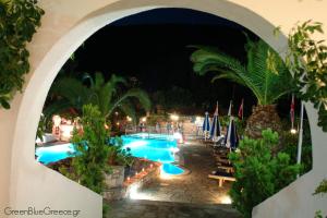 a view of a swimming pool at night at Afroditi in Panormos Skopelos