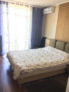 a bed in a room with a window with a curtain at Hotel Paulina in Făleşti