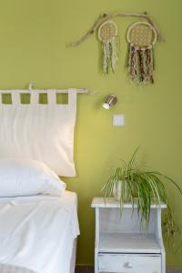 a bedroom with a bed and a green wall at Kassiani Studios in Plakias