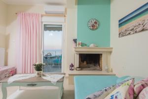a living room with a fireplace and a window at Boutique Apartment Volos in Volos +33 photos