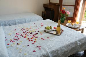 a table with flowers on a bed with a bottle of champagne at Afroditi in Panormos Skopelos