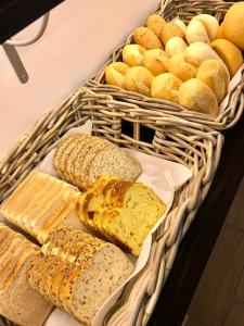 a bunch of breads and bread rolls in baskets at Hostal Casa Mercedes in Nerja