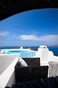 a view of the ocean from a balcony of a resort at Blue Angel Villa in Fira