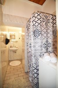 a bathroom with a shower and a toilet and a sink at BETTY'S HOUSE in Pythagoreio +25 photos