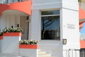 a facade of a building with flowers in windows at Residence Apollo Immobiliare Pacella in Lido di Jesolo