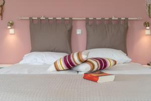 a bed with a pillow and a book on it at Kassiani Studios in Plakias